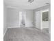 Main bedroom with wood-look flooring, and entrances to bathroom and kitchen at 169 Birmingham Dr, Kissimmee, FL 34758