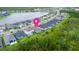 Aerial view of homes with water view in a well-planned neighborhood, marked with a location pin at 180 Azure Mist Way, Daytona Beach, FL 32124