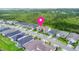 Aerial view of homes in a well-planned neighborhood with lush green spaces, marked with a location pin at 180 Azure Mist Way, Daytona Beach, FL 32124