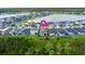 Aerial view of homes with lake view in a well-planned neighborhood, marked with a location pin at 180 Azure Mist Way, Daytona Beach, FL 32124