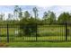Fenced backyard with green grass, shrubs, and trees at 180 Azure Mist Way, Daytona Beach, FL 32124