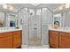 Bathroom featuring a glass shower and double vanity with wooden cabinets at 180 Azure Mist Way, Daytona Beach, FL 32124