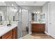 Bright bathroom featuring a glass shower, double vanity and wood flooring at 180 Azure Mist Way, Daytona Beach, FL 32124