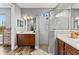 Bathroom showcasing a glass shower, double vanity, and hardwood flooring at 180 Azure Mist Way, Daytona Beach, FL 32124