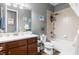 Well-lit bathroom with a vanity, mirror, bathtub and shower combo, and modern fixtures at 180 Azure Mist Way, Daytona Beach, FL 32124