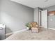 Cozy bedroom featuring a chair, ottoman, neutral colors, and carpet flooring at 180 Azure Mist Way, Daytona Beach, FL 32124