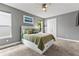 Comfortable bedroom featuring neutral walls, plush carpet, ceiling fan, and a white bed frame with drawers at 180 Azure Mist Way, Daytona Beach, FL 32124