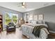 Spacious bedroom featuring a large window, hardwood floors, and neutral decor at 180 Azure Mist Way, Daytona Beach, FL 32124