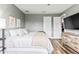 Bright bedroom with modern furnishings, wood flooring, and view of en suite bathroom at 180 Azure Mist Way, Daytona Beach, FL 32124