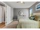 Relaxing bedroom with a white dresser, round mirror, light grey walls, and plush carpeting at 180 Azure Mist Way, Daytona Beach, FL 32124