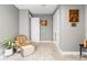 Comfortable bedroom featuring a chair, ottoman, neutral colors, and carpet flooring at 180 Azure Mist Way, Daytona Beach, FL 32124