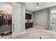 Spacious bedroom featuring a walk-in closet, large window, TV, dresser, and plush carpet flooring at 180 Azure Mist Way, Daytona Beach, FL 32124