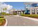 Stunning clubhouse entrance with modern architecture, landscaping, and palm trees, creating a welcoming community space at 180 Azure Mist Way, Daytona Beach, FL 32124