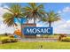 Beautiful community sign with three palm trees, colorful artwork, and the community name, Mosaic at 180 Azure Mist Way, Daytona Beach, FL 32124