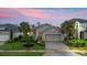Charming single-story home featuring a paved driveway, well-maintained lawn, and tasteful landscaping at 180 Azure Mist Way, Daytona Beach, FL 32124