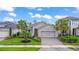 Charming single-story home featuring a paved driveway, well-maintained lawn, and tasteful landscaping at 180 Azure Mist Way, Daytona Beach, FL 32124