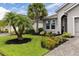 Beautiful single-story home with lush landscaping and a brick driveway at 180 Azure Mist Way, Daytona Beach, FL 32124
