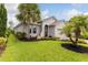Lush landscaping with dark mulch and a manicured lawn frame this charming home's front yard at 180 Azure Mist Way, Daytona Beach, FL 32124