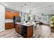Open-concept kitchen with granite countertops and stainless steel appliances flowing into the dining and living area at 180 Azure Mist Way, Daytona Beach, FL 32124