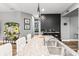 Modern kitchen featuring granite countertops, stainless steel sink, and barstool seating at 180 Azure Mist Way, Daytona Beach, FL 32124