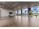 Expansive outdoor patio area with stylish seating, wood flooring, and views of lush landscaping and swaying palm trees at 180 Azure Mist Way, Daytona Beach, FL 32124