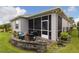 Screened-in patio with outdoor seating and landscape views at 180 Azure Mist Way, Daytona Beach, FL 32124