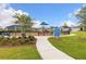 Community playground includes playground rules and a walking path through green lawn at 180 Azure Mist Way, Daytona Beach, FL 32124