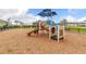 Community playground features a modern play structure with slides and climbing elements on a soft wood chip surface at 180 Azure Mist Way, Daytona Beach, FL 32124