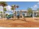 Blue community playground with modern play structure featuring dual slides, climbing elements and lush landscaping surroundings at 180 Azure Mist Way, Daytona Beach, FL 32124
