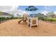 Community playground features a modern play structure with slides and climbing elements on a soft wood chip surface at 180 Azure Mist Way, Daytona Beach, FL 32124