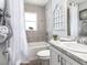 Cozy bathroom featuring tiled walls, a built-in tub, and a vanity with a decorative backsplash and ample lighting at 1846 Daystar Dr, Haines City, FL 33844