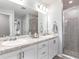 Modern bathroom with dual sinks, granite countertops, sleek cabinetry, and glass-enclosed shower for a spa-like feel at 1846 Daystar Dr, Haines City, FL 33844