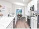 Bright kitchen with white cabinets, stainless steel appliances, granite countertops, and an adjacent dining area at 1859 Daystar Dr, Haines City, FL 33844