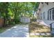 Cozy backyard with white storage shed, stone pavers and mature trees at 213 Cannon St, Lakeland, FL 33803