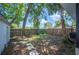 Wide backyard view with stone pavers, mature trees and fenced perimeter at 213 Cannon St, Lakeland, FL 33803