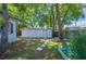View of backyard featuring a storage shed, mature trees and garden at 213 Cannon St, Lakeland, FL 33803