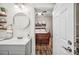 Bathroom with a modern vanity, round mirror, and view to the bedroom at 213 Cannon St, Lakeland, FL 33803