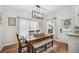 Bright dining room with a wooden table, bench, and modern lighting fixture at 213 Cannon St, Lakeland, FL 33803