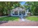 Charming single-story home featuring a welcoming front porch, classic design, and lush landscaping at 213 Cannon St, Lakeland, FL 33803