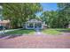Inviting single-story home with a cozy front porch, well-maintained lawn, and mature trees at 213 Cannon St, Lakeland, FL 33803