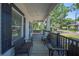 Charming covered front porch providing ample seating, exterior lighting, and shaded comfort at 213 Cannon St, Lakeland, FL 33803
