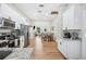 Open kitchen featuring stainless steel appliances, granite countertops, and views into the living area at 213 Cannon St, Lakeland, FL 33803