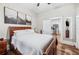 Bright main bedroom showcasing a queen size bed, wood floors, and stylish decor at 213 Cannon St, Lakeland, FL 33803