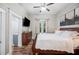 Comfortable bedroom with a queen size bed, wooden dresser, and natural light at 213 Cannon St, Lakeland, FL 33803