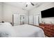 Cozy bedroom featuring wood flooring, a large bed, and ample closet space at 213 Cannon St, Lakeland, FL 33803