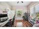 Bright office featuring an gaming chair, hardwood floors, and a gun safe at 213 Cannon St, Lakeland, FL 33803
