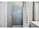 Tiled shower with a decorative curtain and a gray vanity at 213 Cannon St, Lakeland, FL 33803