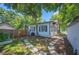 Side view of house and yard with white storage shed and stone pavers at 213 Cannon St, Lakeland, FL 33803