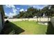 Expansive backyard featuring a well-maintained lawn, privacy fence, and pergola-covered patio area at 2169 Rush Bay Way, Orlando, FL 32824