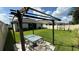 Lush backyard featuring a patio area and dining set under a pergola, perfect for outdoor entertaining at 2169 Rush Bay Way, Orlando, FL 32824